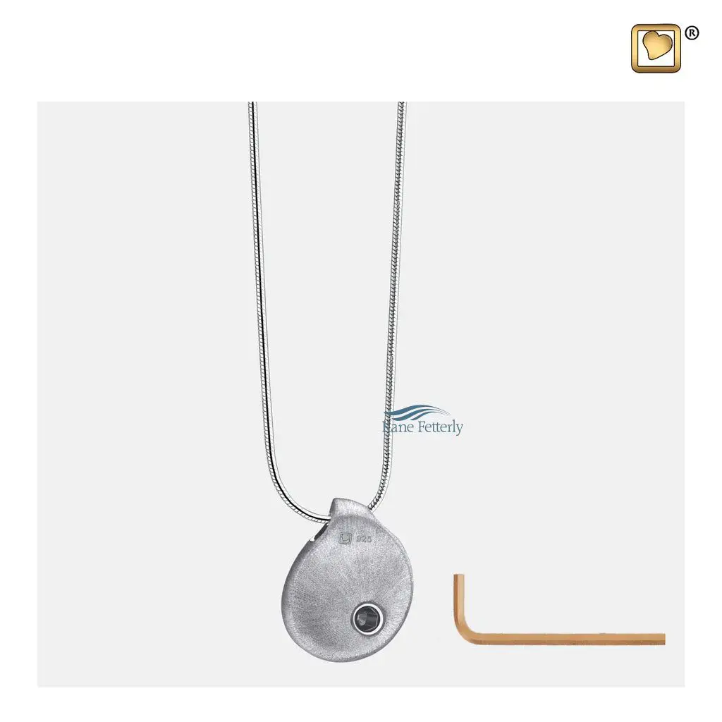 The pendant features a small compartment to hold a token of ashes.