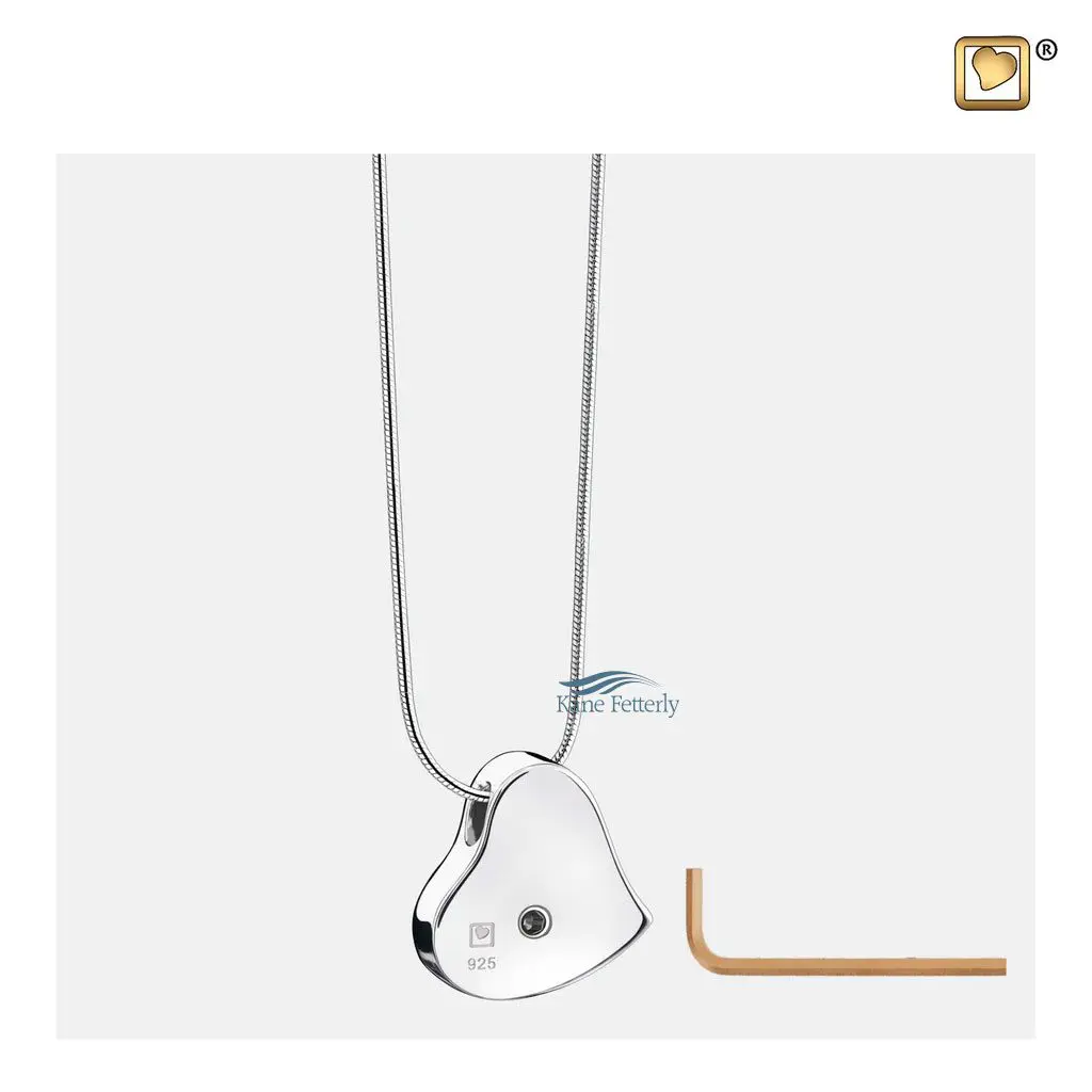 The pendant features a small compartment to hold a token of ashes.