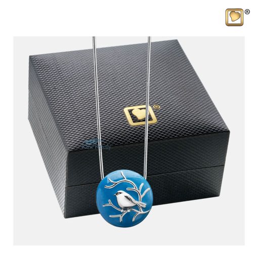 Pendentif cinéraire rond à motif d’oiseau argenté illustré avec coffret à bijoux