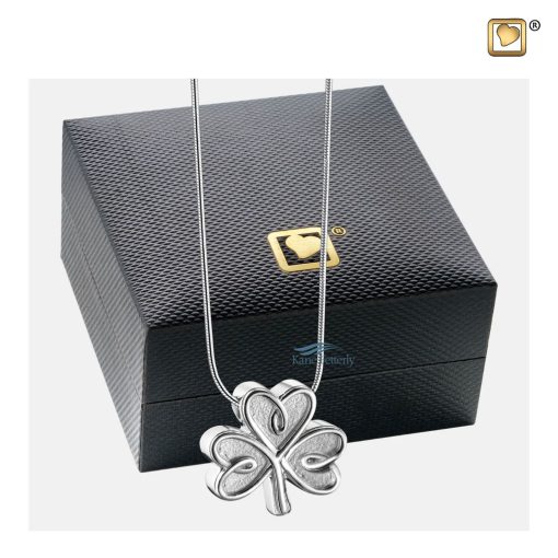 Shamrock pendant for ashes shown with jewelry box