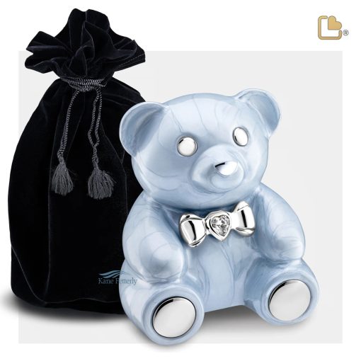 Urne pour enfant en forme d'ourson, présentée avec sac en velours.
