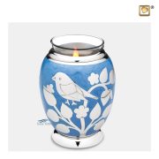 Tealight keepsake urn with bird and floral motifs on a blue enamel surface
