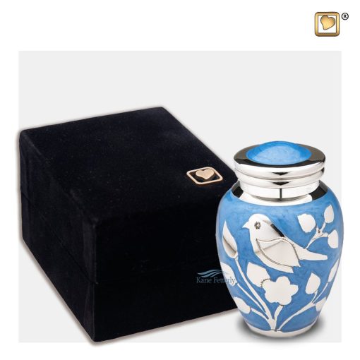 Brass miniature urn with bird and foliage motifs on a blue enamel shown with box