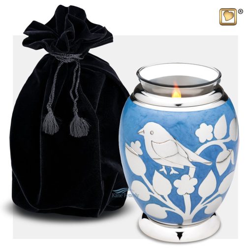 Tealight keepsake urn with bird and floral motifs shown with velvet bag