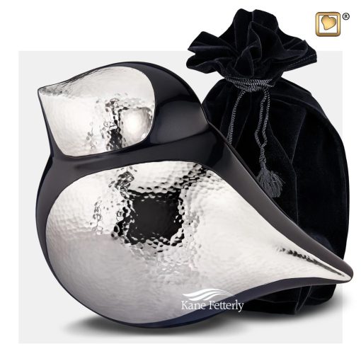 Black and silver bird urn shown with velvet bag