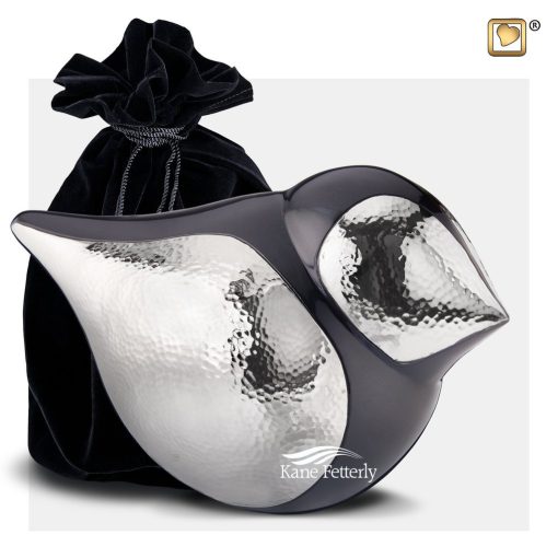 Black and silver bird urn shown with velvet bag